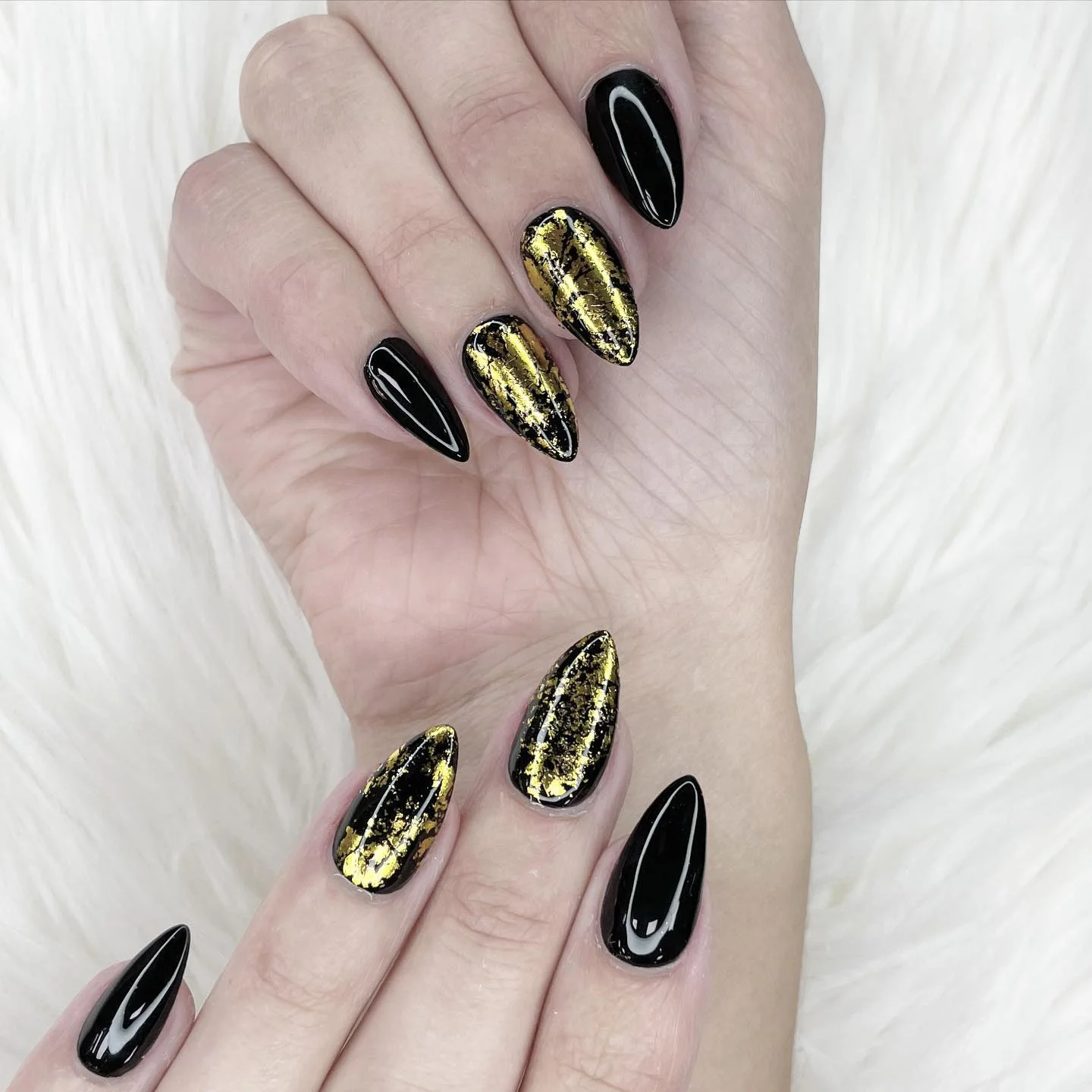 Black manicure with sculptural gold texture