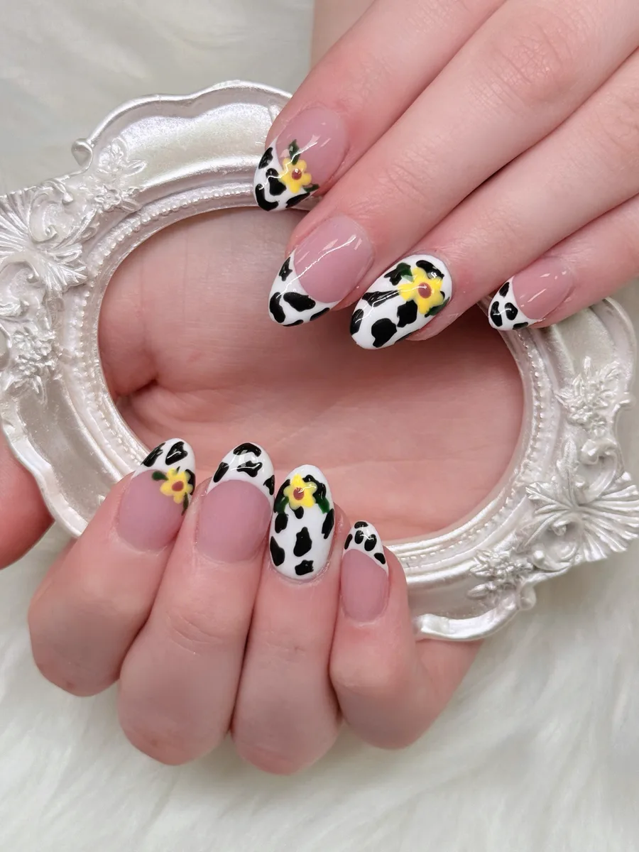 Cow-print French manicure with floral accents