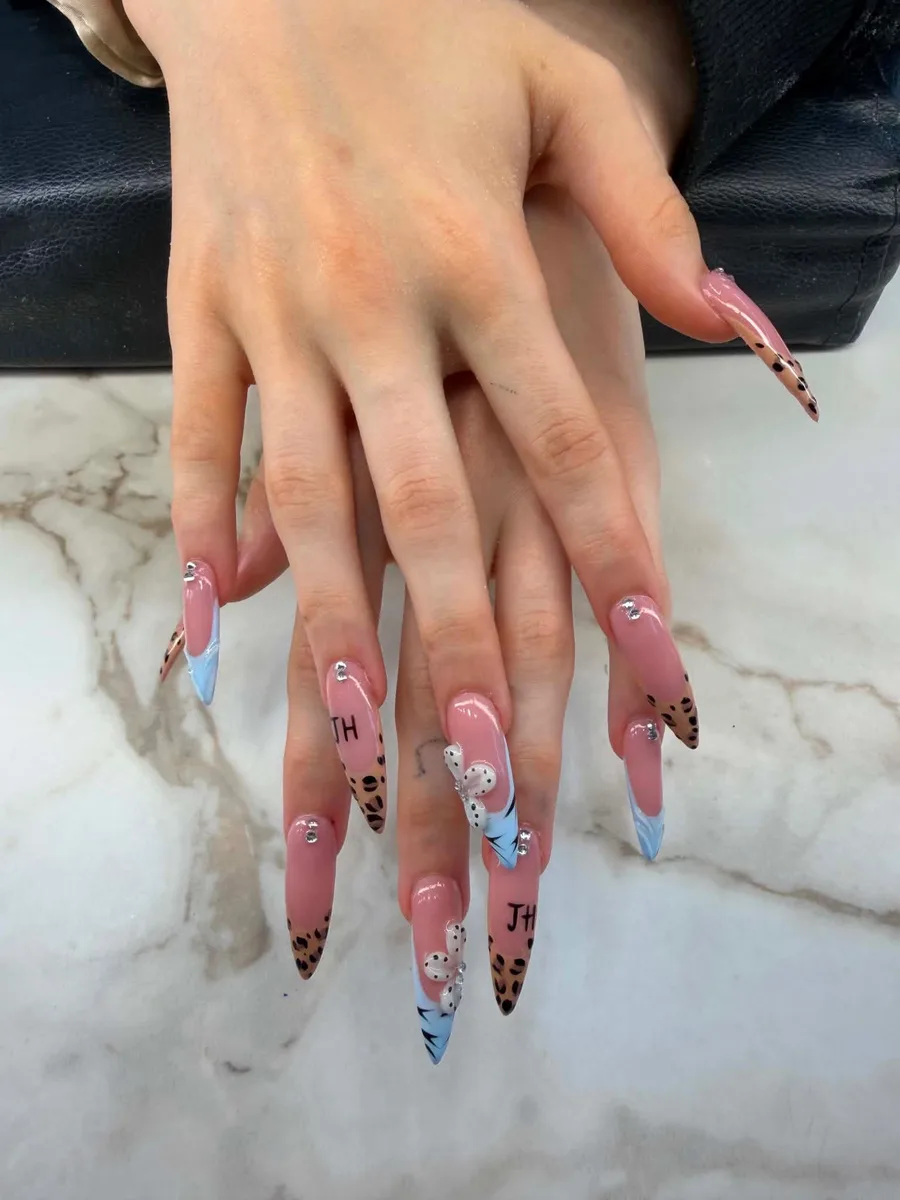 Long pink illustrated nails with blue accents