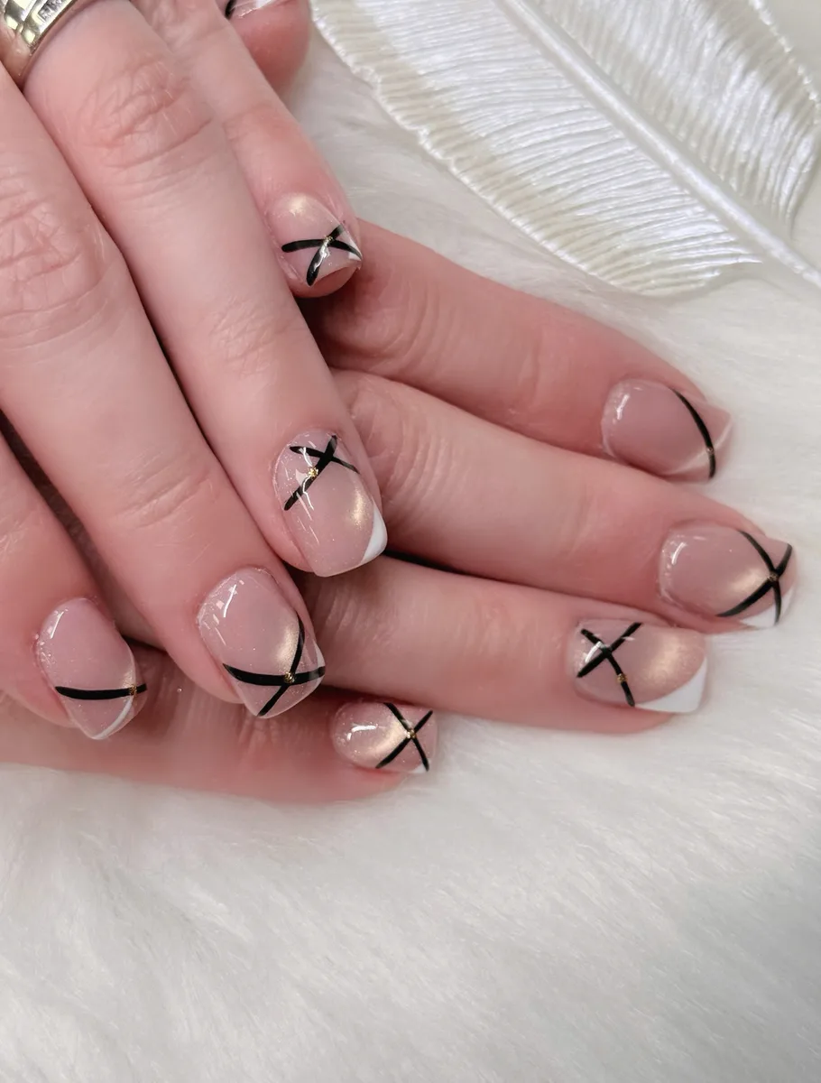 Soft nude manicure with graphic black French lines